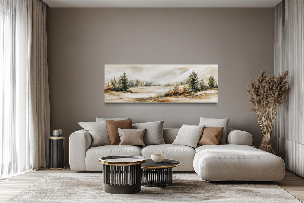 Panoramic canvas print of a neutral landscape with beige and green trees over a modern sofa.