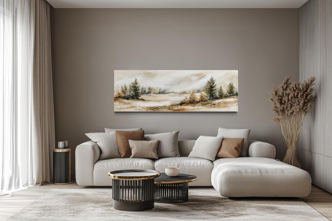 Panoramic canvas print of a neutral landscape with beige and green trees over a modern sofa.