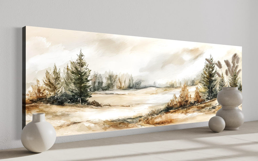 Panoramic canvas print of a neutral landscape with beige and green trees in a minimalist room.
