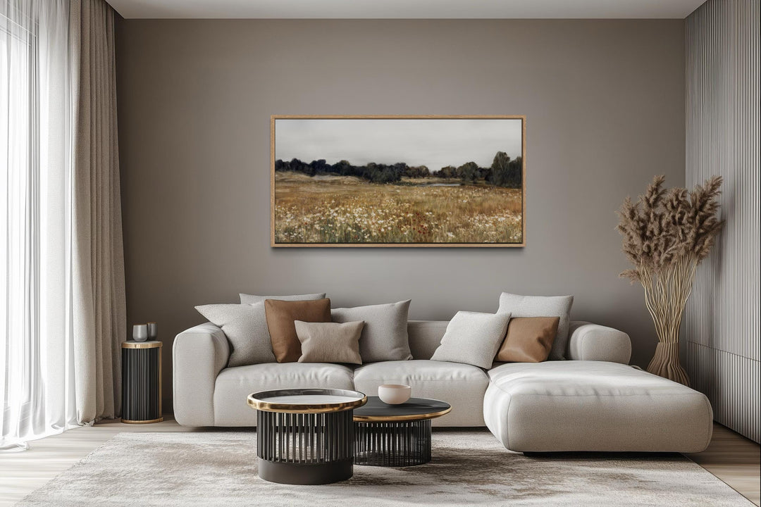 Neutral wildflower field landscape canvas wall art above a sofa in a farmhouse living room.
