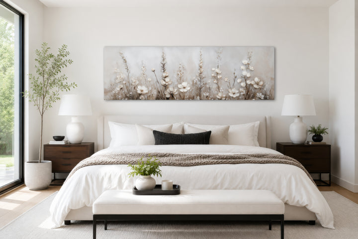 Neutral wildflower canvas wall art in a beige floral landscape style above a modern bed.