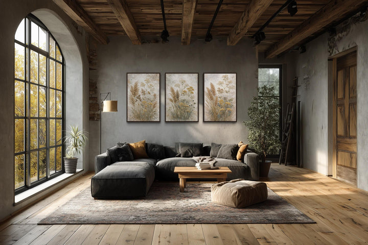 Set of three neutral wildflower botanical canvas prints featuring beige floral designs on a wall.