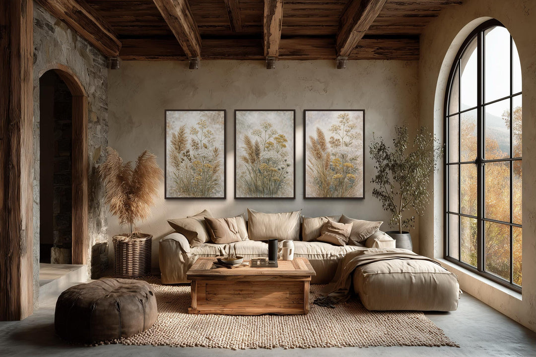 Set of three botanical canvas prints featuring neutral wildflowers in a rustic living room.