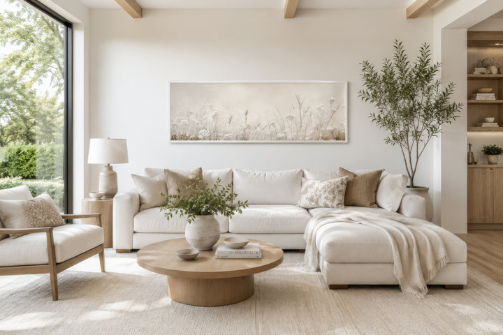Neutral wildflowers wall art in a beige botanical canvas print above a white sectional sofa.