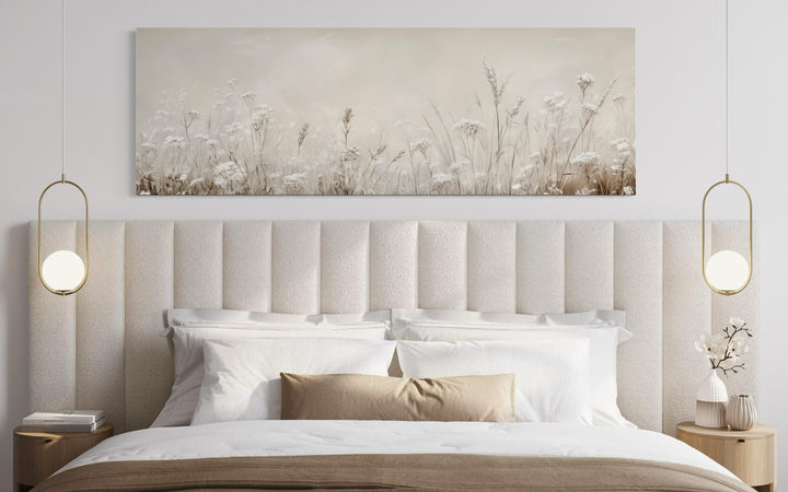Horizontal panoramic canvas print of neutral wildflowers in beige tones above a modern bed.