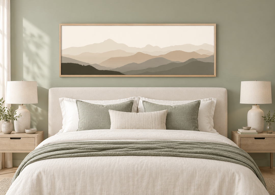 Minimalist mountain landscape wall art in beige and brown tones hanging above a bed.