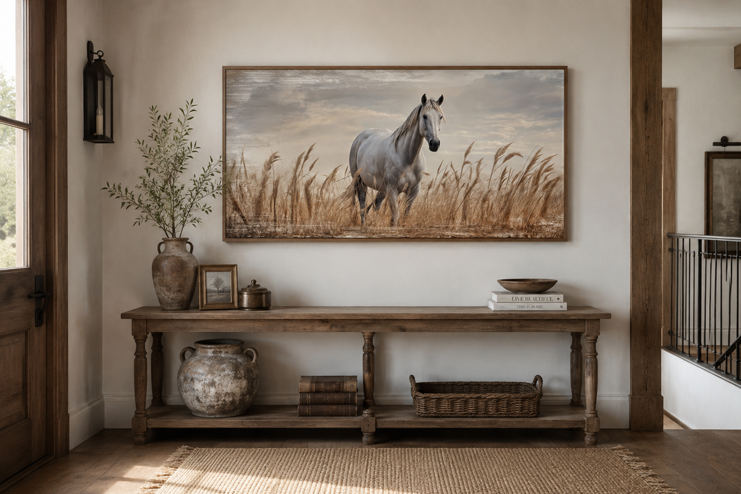 Framed canvas wall art of a white horse in a golden wheat field above a rustic console table.