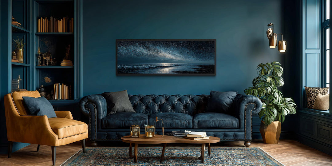 Panoramic dark blue seascape canvas print of a night ocean under a starry sky in a modern room.