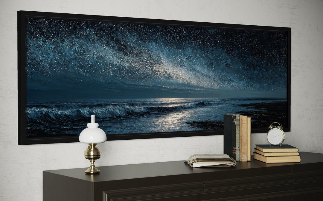 Panoramic dark blue seascape canvas print of a night ocean under a starry sky in a black frame.