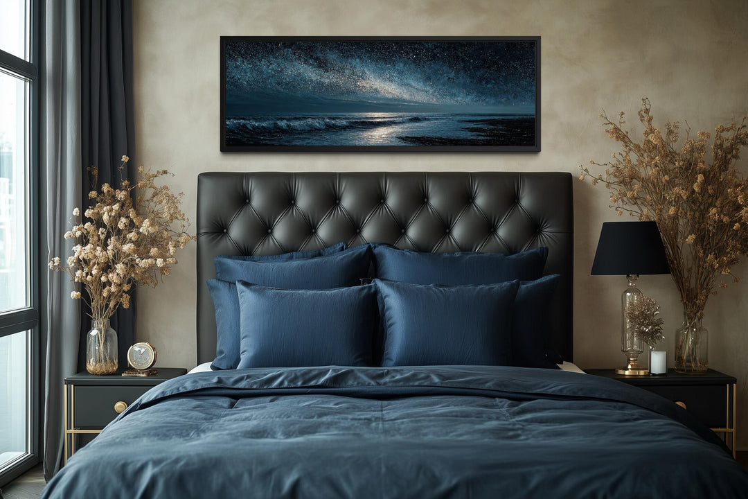 Panoramic dark blue seascape canvas print with a starry sky above a modern bedroom headboard.