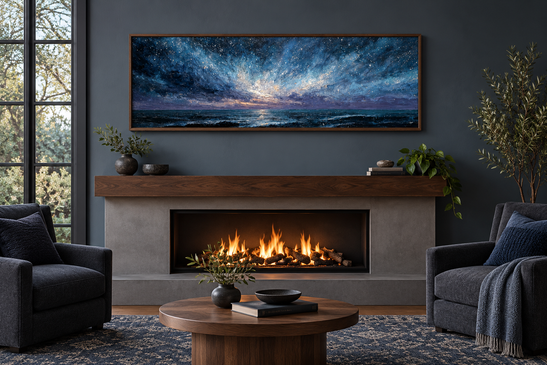 Panoramic moody seascape canvas print with navy and purple sky above a fireplace in a modern room.