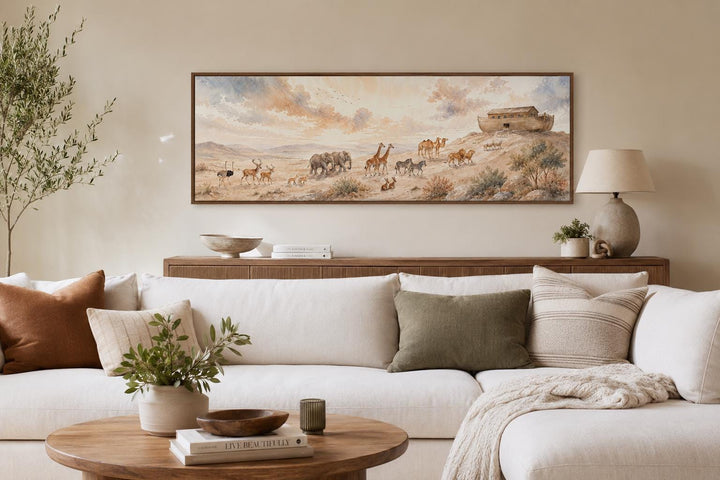 Noah's Ark watercolor painting on a horizontal canvas above a white sofa in a neutral living room.