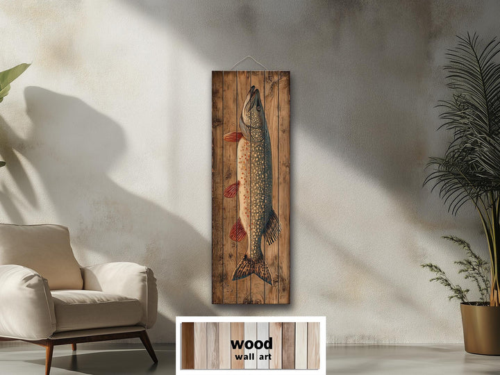 Northern pike vertical wall art on distressed wood planks in a rustic cabin setting.