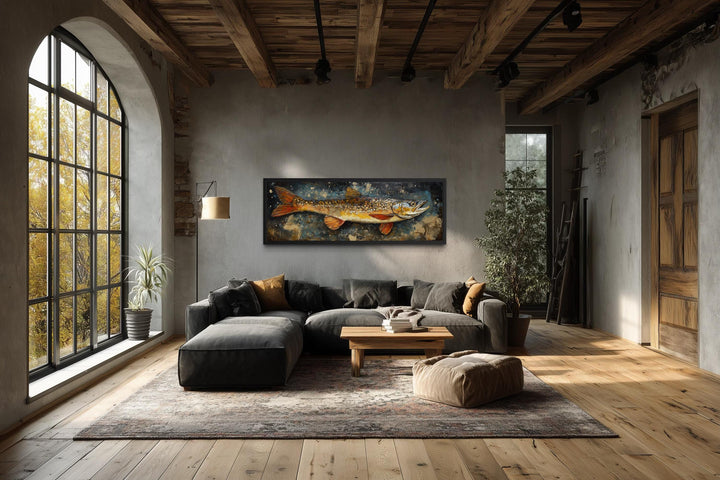 Northern Pike wall art in a rustic lodge-style living room with a dark sofa and wood beams.