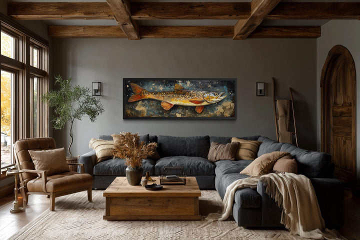 Northern Pike wall art in a rustic lodge-style living room with a dark sofa and wood beams.