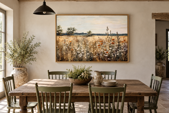 Wildflowers field vintage farmhouse framed canvas wall art above a rustic wooden dining table.