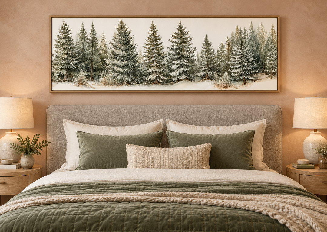 Sage green pine trees wall art in a long horizontal frame above a bed with green and cream bedding.