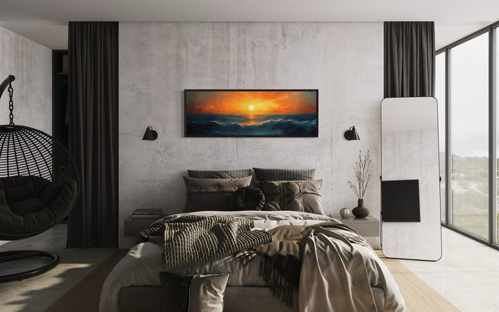 Ocean sunset long horizontal framed canvas wall art hanging above a bed in a modern bedroom.