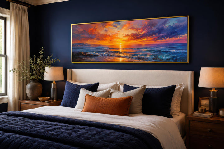 Ocean Sunset Wall Art: Long horizontal canvas with a fiery purple and orange sky above a bed.