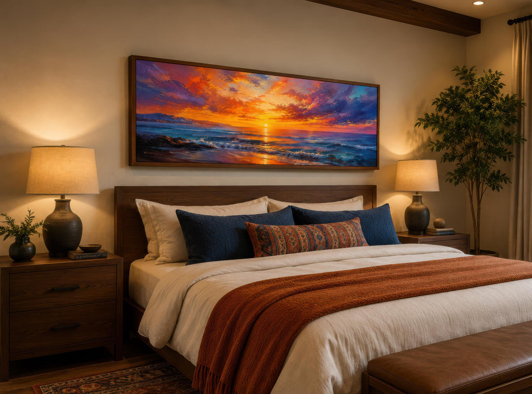 Long horizontal canvas of a fiery ocean sunset with purple and orange sky above a wooden bed.