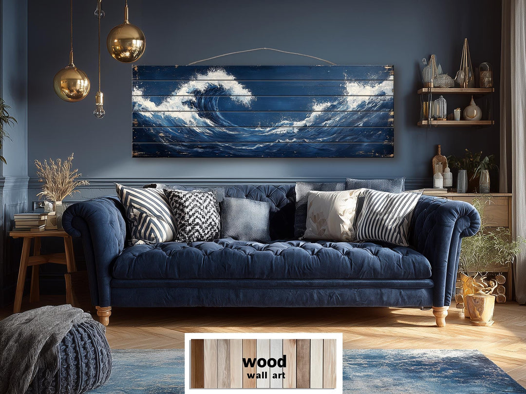 A long, narrow wood wall art piece featuring a distressed ocean wave print above a blue sofa.