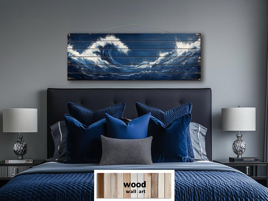Ocean wave long narrow nautical distressed wood wall art hanging above a blue bed.