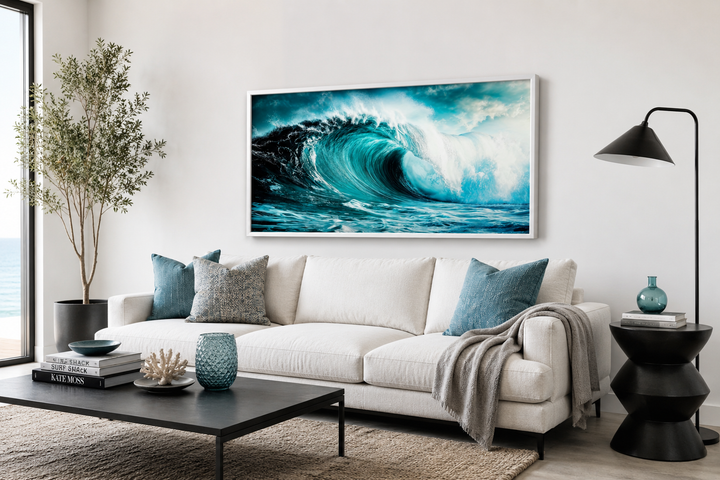 Ocean wave photography framed canvas wall art above a white sofa in a modern living room.