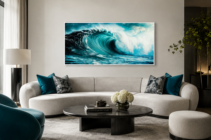 Ocean wave photography framed canvas wall art hanging above a modern curved sofa in a living room.