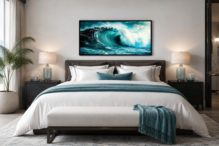 Ocean wave photography framed canvas wall art hanging above a bed in a modern coastal bedroom.