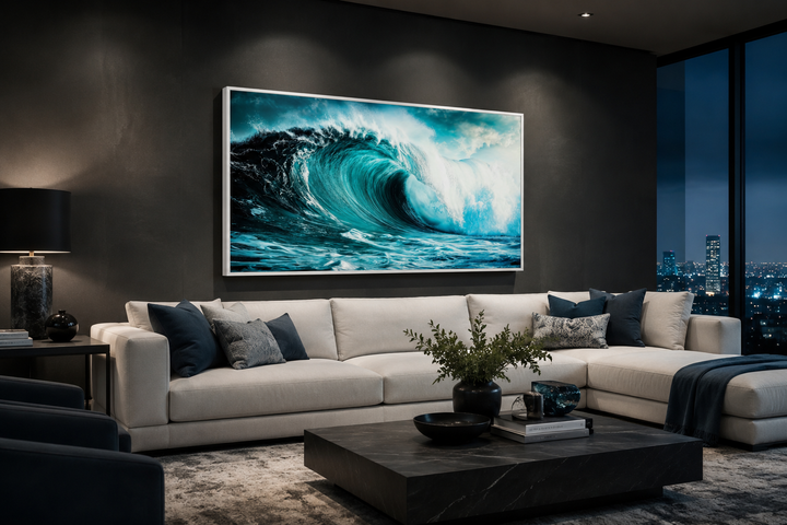 Large framed canvas wall art featuring a crashing teal ocean wave above a white sectional sofa.