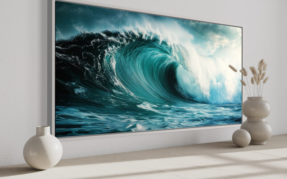 Ocean wave photography framed canvas wall art in a modern room with decorative vases.