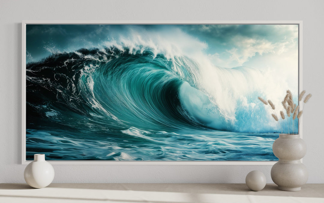Ocean wave photography framed canvas wall art featuring a crashing turquoise wave in a white frame.