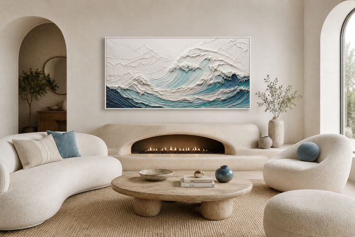 Textured 3D teal ocean wave canvas art above a modern fireplace in a neutral living room.