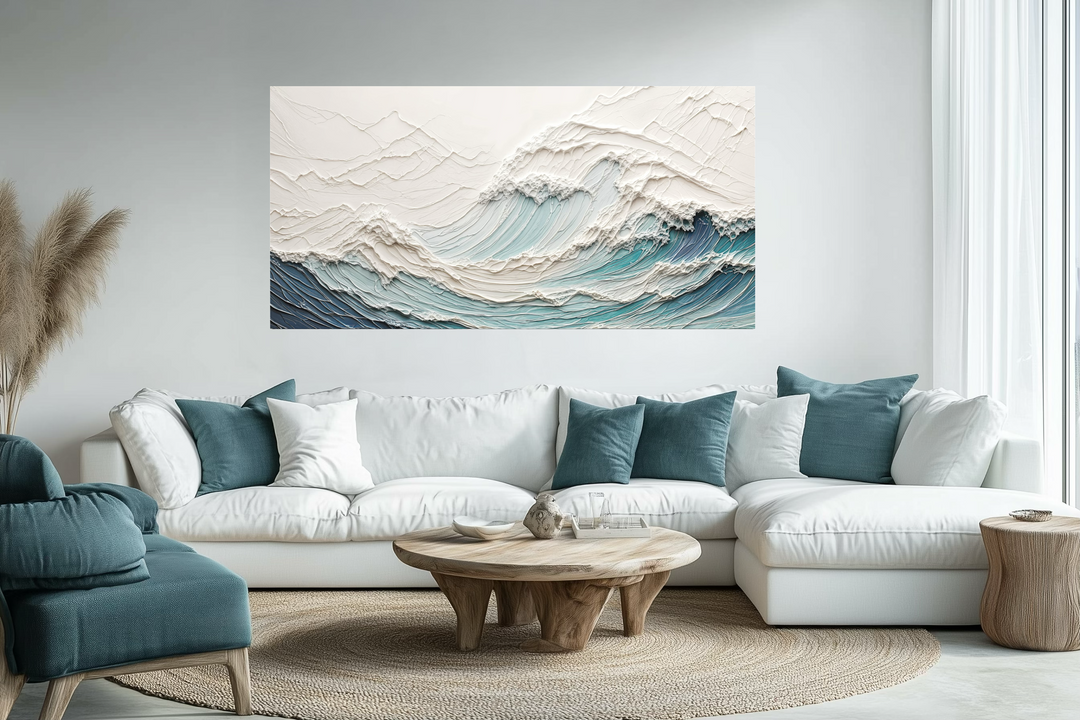 Textured teal and white ocean wave canvas art displayed above a modern white sectional sofa.