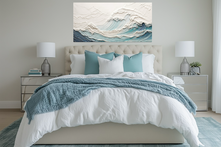 Textured teal and white ocean wave canvas art hangs above a modern neutral-toned bed.