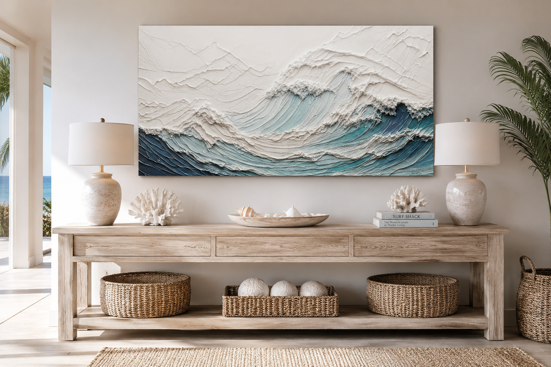 Textured 3D teal ocean wave canvas art above a wooden console table with coastal decor.