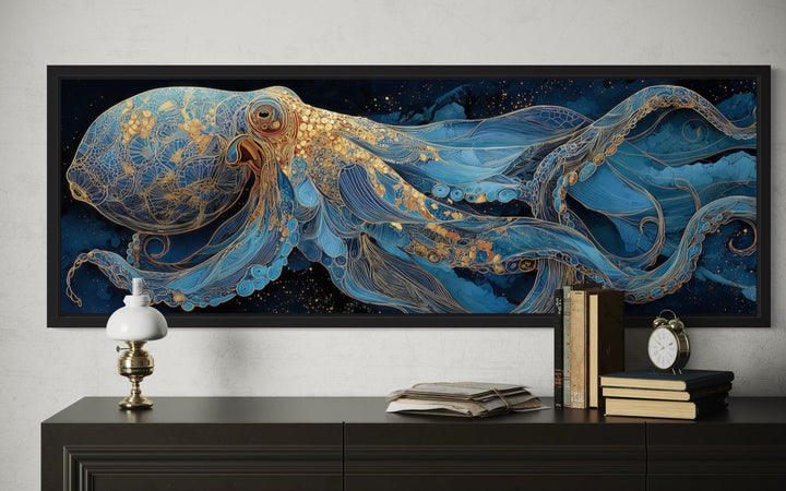 Horizontal canvas wall art of a blue and gold octopus above a dark wood console table.