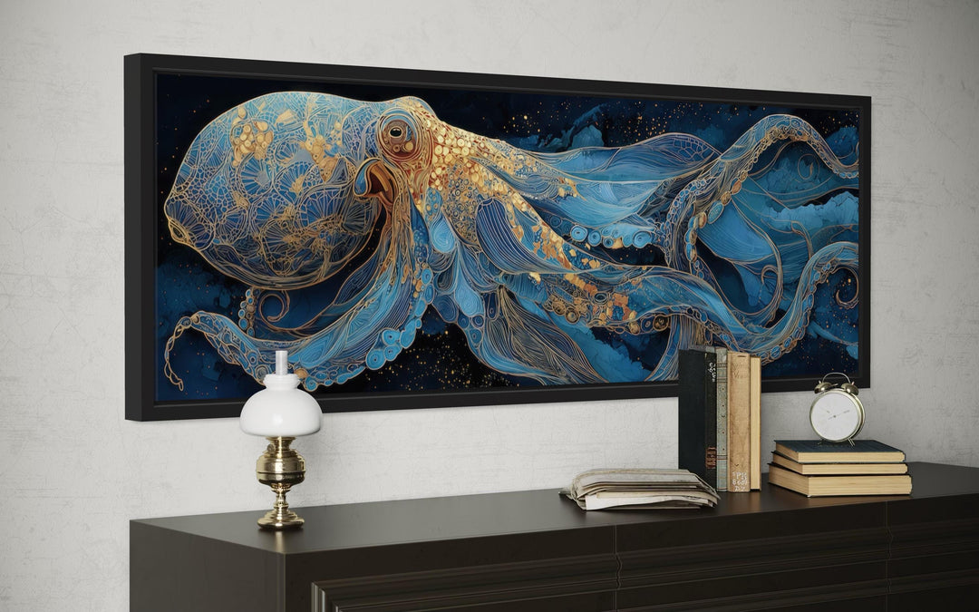 Horizontal canvas wall art of a blue and gold octopus above a dark wood console table.