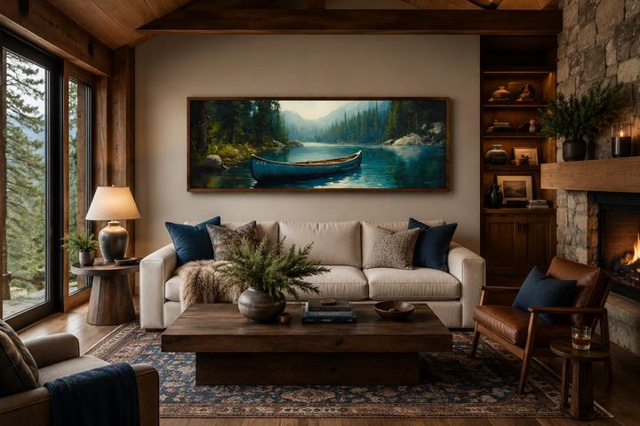 Old blue canoe in a lake long horizontal framed canvas wall art hanging above a sofa in a cabin.