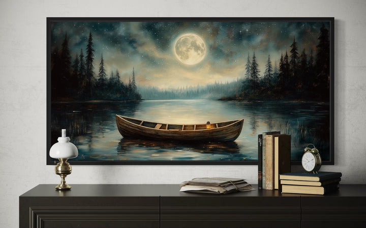 Framed canvas wall art of a rustic wooden boat on a calm lake under a full moon at night.