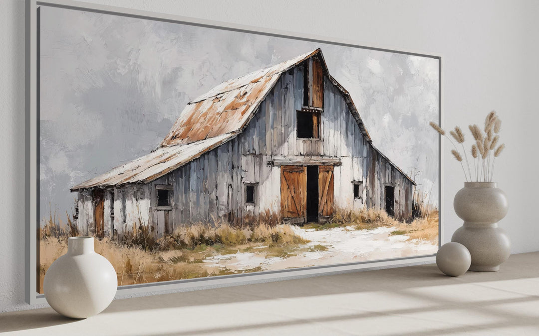 Rustic canvas wall art of an old grey barn with a rusted roof in a farmhouse style setting.