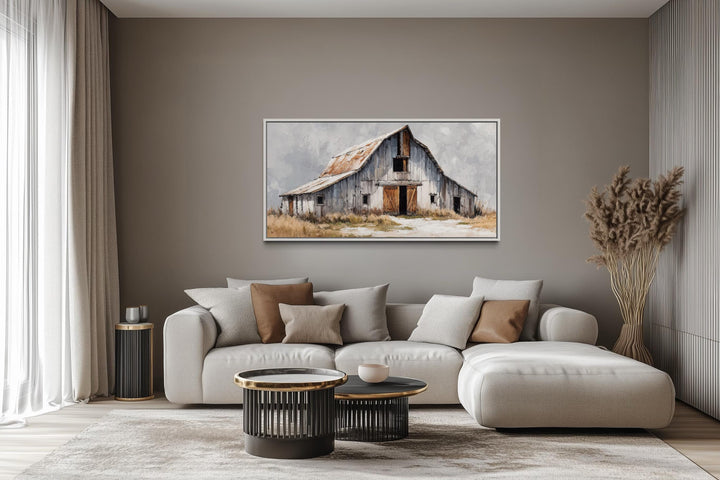 Old grey barn canvas wall art in a rustic farmhouse living room above a neutral sofa.