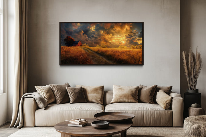Old red barn in autumn sunset framed canvas wall art hanging above a modern beige sofa.