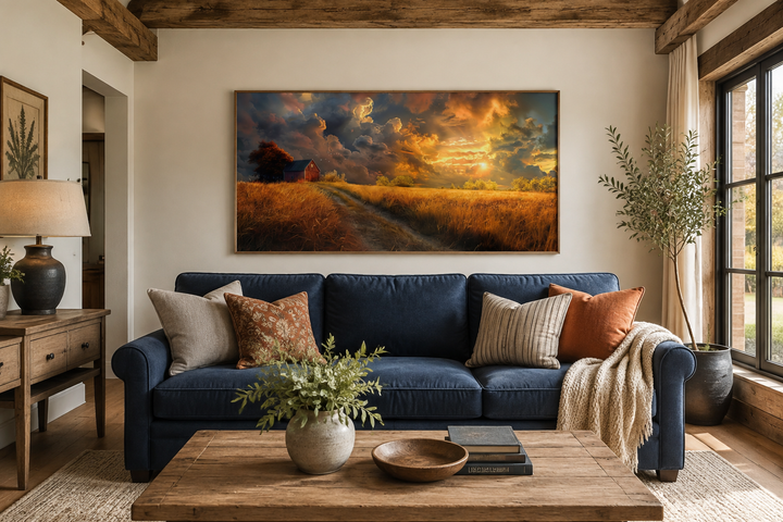 Old red barn in autumn sunset framed farmhouse canvas wall art hanging above a blue sofa.