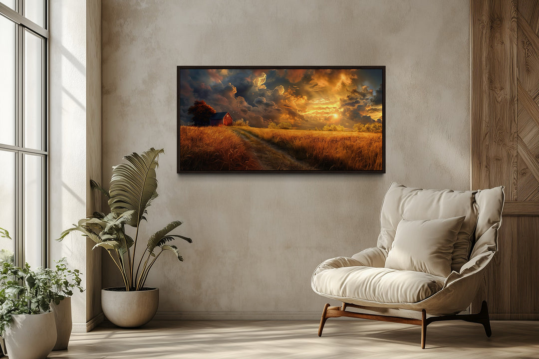 Old red barn in autumn sunset framed canvas wall art hanging in a modern rustic living room.