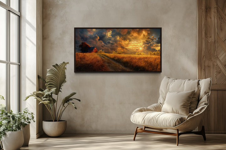 Old red barn in autumn sunset framed canvas wall art hanging in a modern rustic living room.