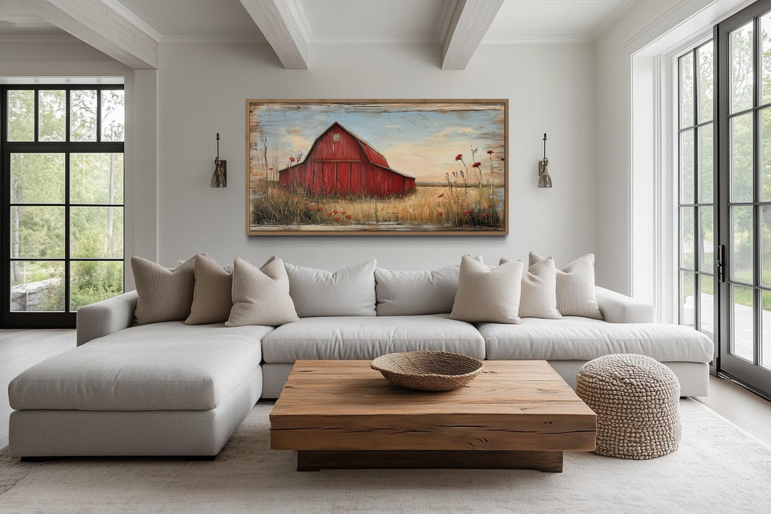 Old red barn on weathered wood canvas wall art hanging above a modern sofa in a farmhouse living room