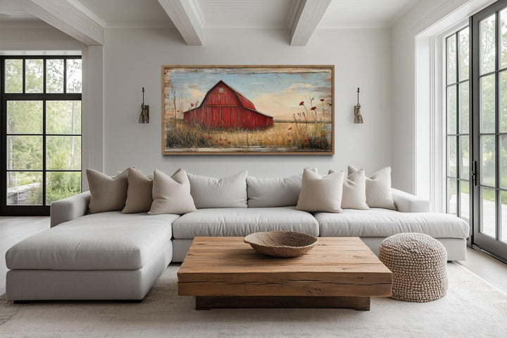Old red barn on weathered wood canvas wall art hanging above a modern sofa in a farmhouse living room