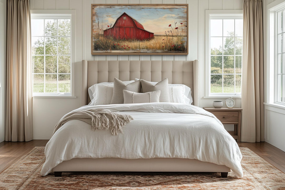 Old red barn on weathered wood canvas wall art hanging above a bed in a farmhouse bedroom.