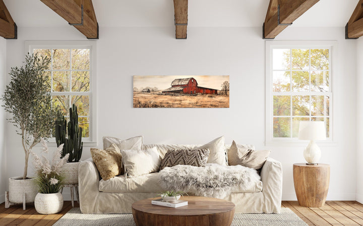 Horizontal painting of a red barn in a field.